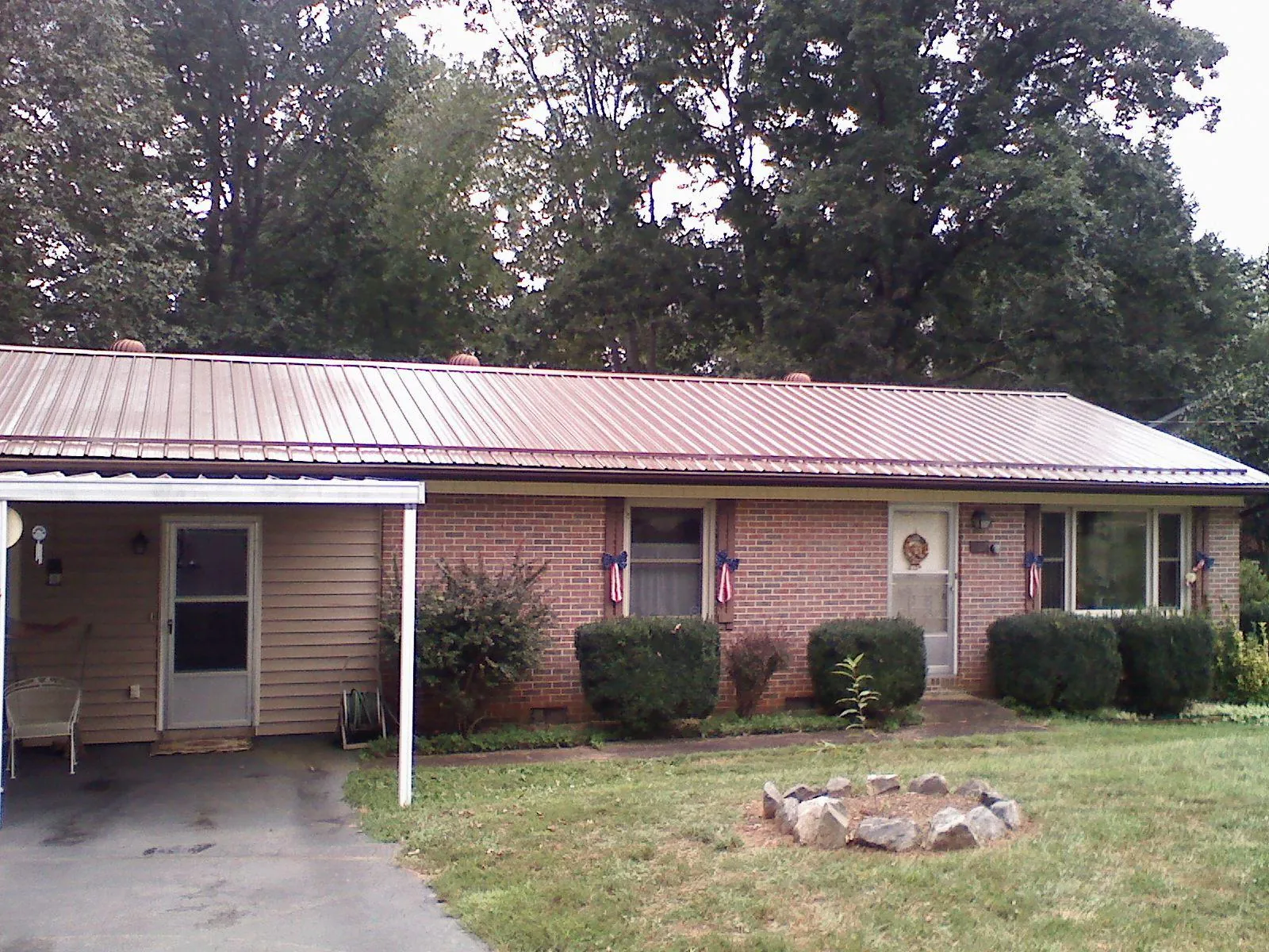 Bronze metal roof and carport on a brick ranch home — Roof Repair work by our crew in Monmouth Beach