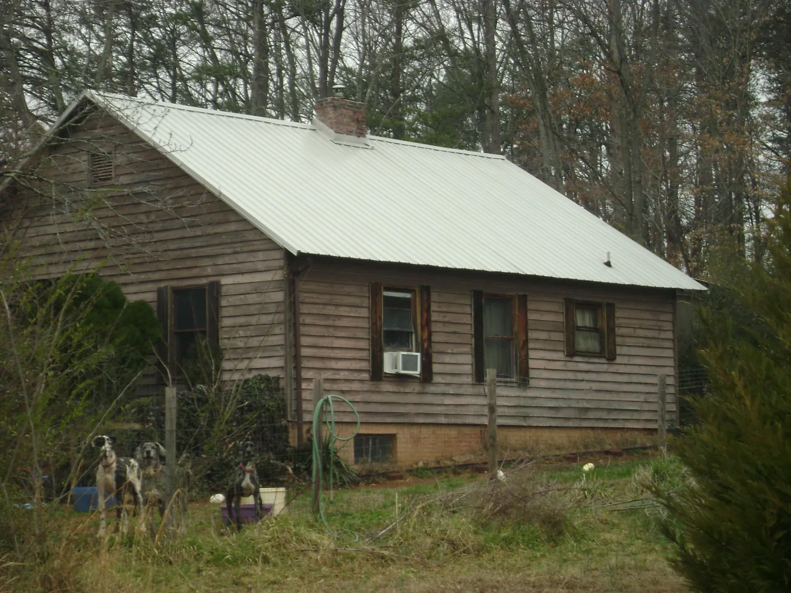 White metal roof on an old wood sided farmhouse, from a Metal Roof Installation job in Monmouth Beach